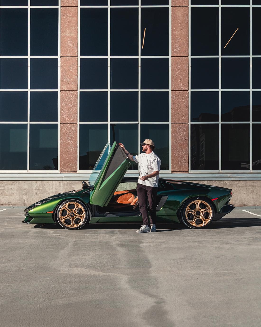Ben Grill opening the scissor door of a green Lamborghini